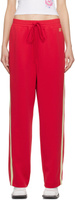 Красные спортивные брюки с полосками по бокам Lesugiatelier